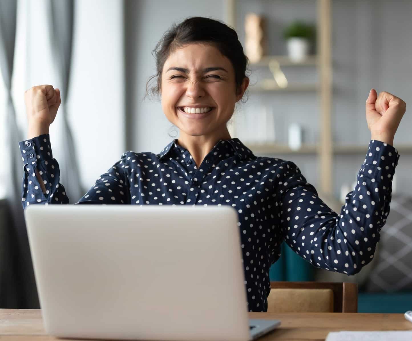 Euphoric young indian girl celebrate online victory triumph with laptop